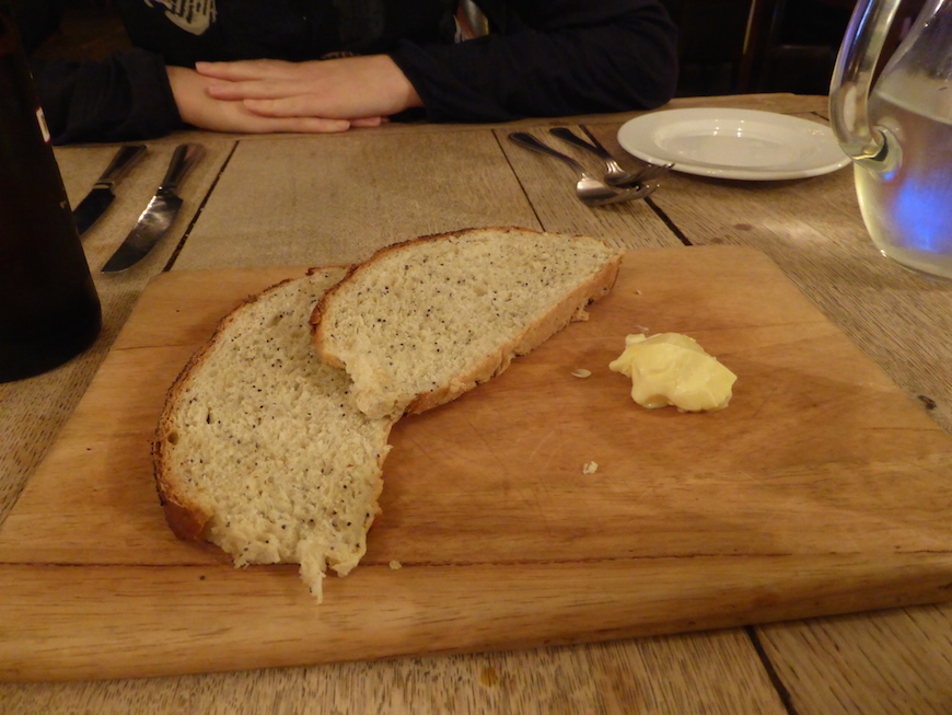 Bread on a wooden plate served as a starter to every meal at The Larder on Goosegate